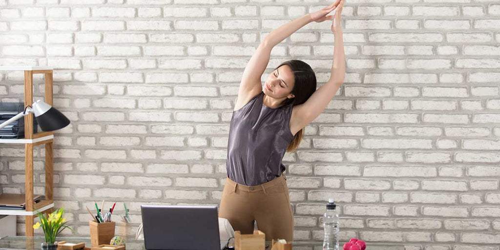 Yoga Poses You Can Do While Sitting at Your Desk