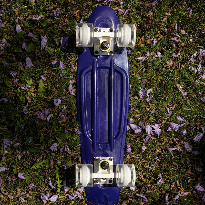 22-inch dark purple mini cruiser with white trucks and clear wheels with a light purple core